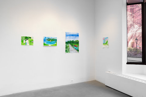 Installation view of four works in the exhibition. On the left wall, there are three works and on the right wall there is one work beside a large, tall window that takes up the top three fourths of the wall. On the left wall, the first work is a painting of a green field where a figure is lying underneath a white blanket. The middle work is a landscape painting which includes a blue body of water surrounded by green hills and mountains. The last work on the left wall is of a grey road as it disappears into the distance. Alongside the road is a small turquoise house with a red-shilling roof. In the background there are blue skies and mountains. On the right wall is a painting of two pink flowers with green stems and leaves. The background is blue on the top and white on the bottom. 