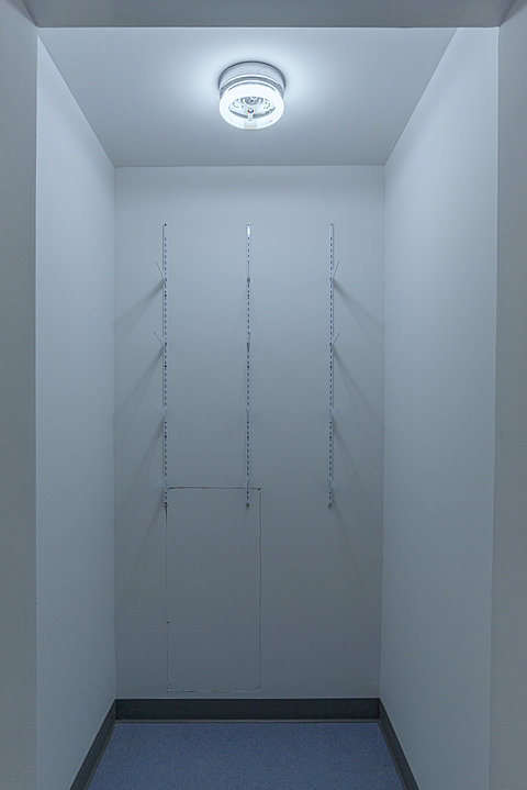 A small white closet with bare shelving racks.