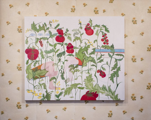 Close up image of a painting hanging on a wall covered in beige, floral wallpaper. The painting consists of several tomato plants against a white, unfinished background. 