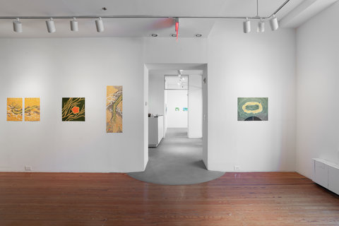 Installation view of four works separated by the door in the gallery space.  