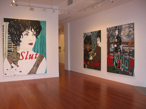 Gallery installation view of three large paintings. From left to right in the gallery space, there is a large painting of a woman with short curly hair looking off into the distance. The word 'slut' is painted across the painting in a large font. 