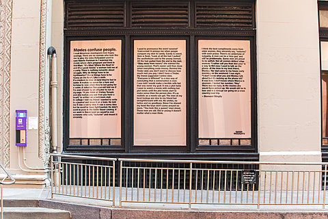 A three panel window is covered with a long poem in san-serif font.