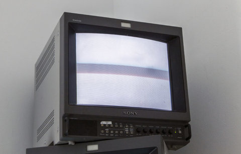 Image of a television monitor from the exhibition. The monitor features grey static. 