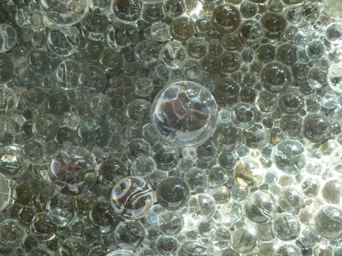 Close-up image of hundreds to thousands of glass orbs or bubbles covering the entire shot. 
