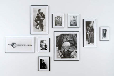 Up close image of nine framed black and white photographs. 
