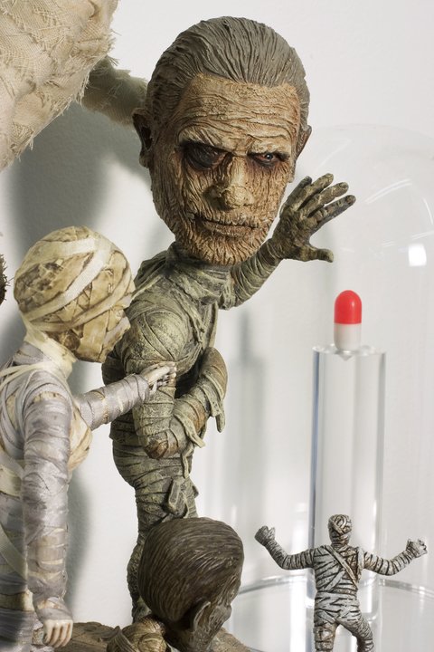 Close-up image of a sculpture in the exhibition featuring a several zombie and mummy figurines. 