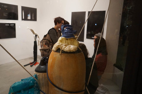 Installation view of the exhibition featuring visitors frequenting the gallery space. 