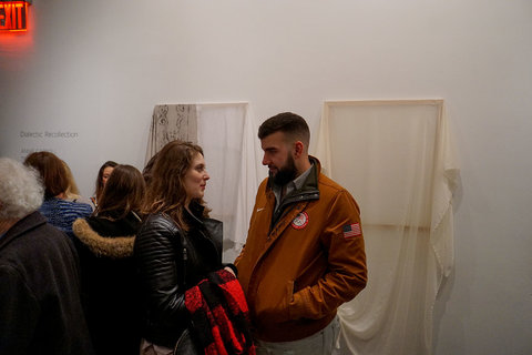 Installation image of visitors frequenting the exhibition. 