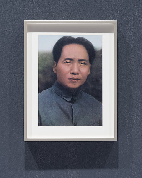 A framed picture of Chairman Mao.